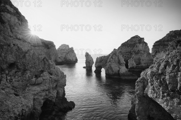 Coloured cliffs and sunrise, rocks in the sea, Ponta da Piedade, Lagos, cliffs, Atlantic Ocean, black and white, Algarve, Portugal, Europe