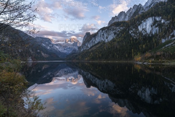 The Vordere Gosausee lake in autumn with a view of the Dachstein mountain range. The Gosaukamm on the right. Good weather, blue sky, a few clouds. In the evening, at sunset. Reflection. Vorderer Gosausee, Gosau, Gosau valley, Salzkammergut, Upper Austria, Austria, Europe