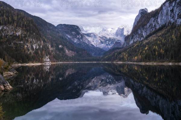 The Vordere Gosausee lake in autumn with a view of the Dachstein mountain range. The Gosaukamm on the right. Clouds in the sky. Vorderer Gosausee, Gosau, Gosau valley, Salzkammergut, Upper Austria, Austria, Europe