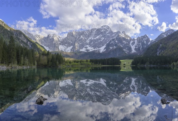 The Mangart mountain range reflected in Lake Fusine, Tarvisio, province of Udine, Italy, Europe