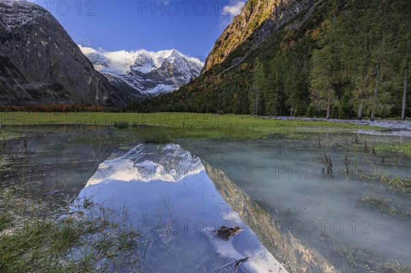 Snow-covered mountains reflected in lake, pond, autumn, Großer Ahornboden, Karwendel Mountains, Tyrol, Austria, Europe