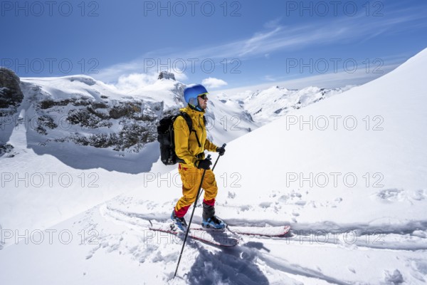 Ski tourer in mountain landscape with snow, ascent to Wildstrubelhütte, Bernese Alps, Switzerland, Europe