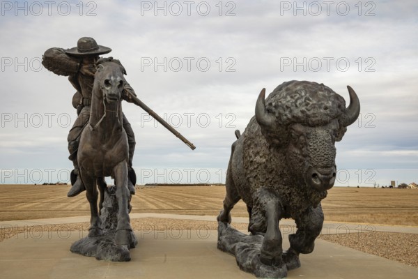 Oakley, Kansas - A sculpture of Buffalo Bill (William Frederick Cody) on horseback shooting a buffalo at the Buffalo Bill Cultural Center. The sculpture is by Charlie Norton.