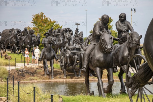 Oklahoma City, Oklahoma - A sculpture commemorates the Oklahoma Land Run of 1889 when thousands of settlers were allowed to enter former Indian Territory and stake claims to the land. The sculpture, by artist Paul Moore, includes 45 figures stretching 365 feet along the Bricktown Canal.