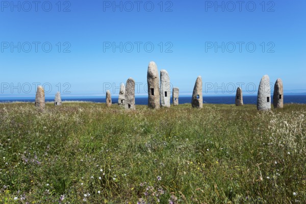 Group of standing stones in a meadow, surrounded by nature and under a blue sky with the sea in the background, Menhires por la Paz, menhirs symbolising peace, Campo de la Rata, A Coruña, A Coruna, La Coruña, La Coruna, Galicia, Spain, Europe