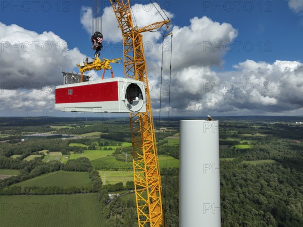 Dorsten, North Rhine-Westphalia, Germany, construction of a wind turbine, the first wind turbine of the Große Heide wind farm. A large mobile crane places the nacelle, the nacelle on the tower, Europe