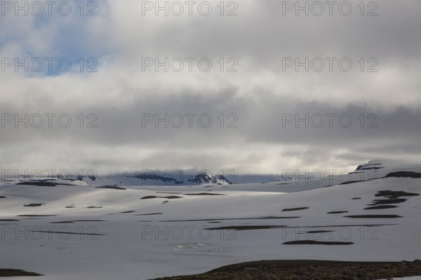 Snowfields at the Heidarvatn lake between Seydisfjördur and Eglisstadur in E Iceland