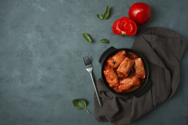 Stuffed cabbage rolls in tomato sauce stuffed cabbage leaves, minced meat with rice, on a dark background, top view, no people