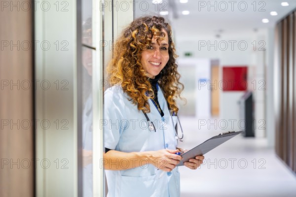Portrait of a nurse holding a medical record smiling at camera