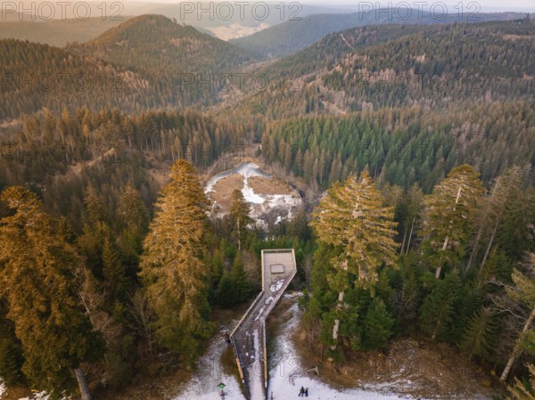Panoramic view from the wooden walkway over snow-covered hills and forests, Ellbachseeblick viewing platform, Baiersbronn, Black Forest, Germany, Europe