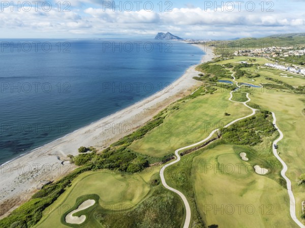 The La Hacienda Links Golf Resort at the Mediterranean Sea with the Rock of Gibraltar (British) in the distance. Aerial view. Drone shot. Cádiz province, Andalusia, Spain, Europe