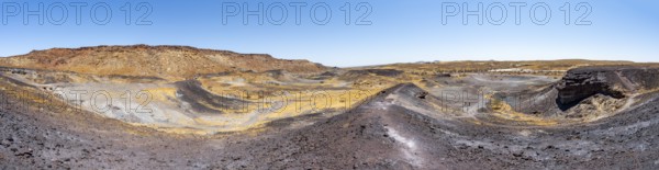 Dry landscape with yellow grass and black volcanic hills, Burnt Mountain, Damaraland, Kunene, Namibia, Africa