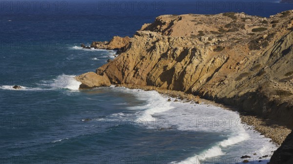 Steep cliffs with rolling waves under a clear sky, west coast, Karpathos, Dodecanese, Greek Islands, Greece, Europe