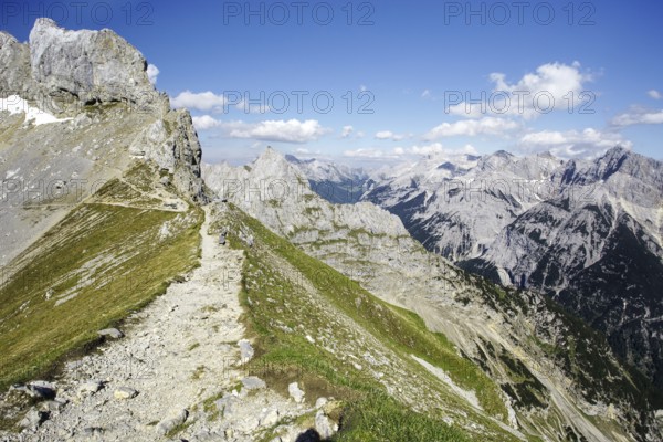 A hiking trail on a ridge with a view of a mountain landscape, Karwendel, Mittenwald, Bavaria, Germany, Europe