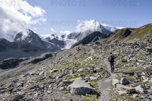 Mountaineer on a hiking trail, behind glacier Glacier de Cheilon and summit Mont Blanc de Cheilon, Valais Alps, Valais, Switzerland, Europe