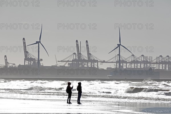 Silhouettes of wind turbines, harbour, people, beach, sea, Hoek van Holland, Rotterdam, Netherlands