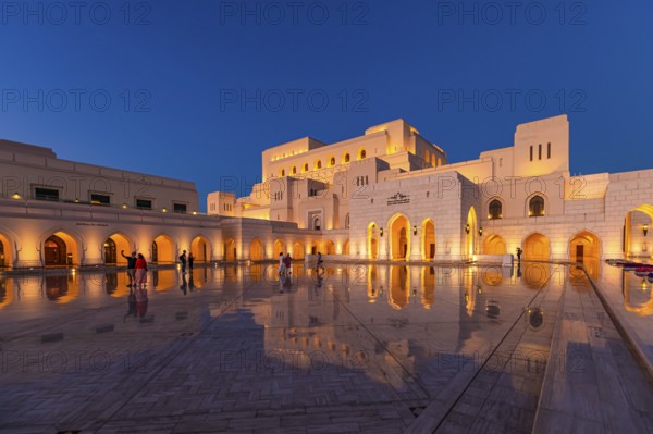 Visitors view the main square in front of the Royal Opera in the evening light, Muscat, Arabian Peninsula, Sultanate of Oman