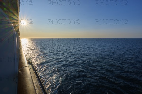 View from cruise ship, Mein Schiff 6, onto the wide sea at sunrise, under a clear blue sky, autumn, North Sea, Denmark, Europe