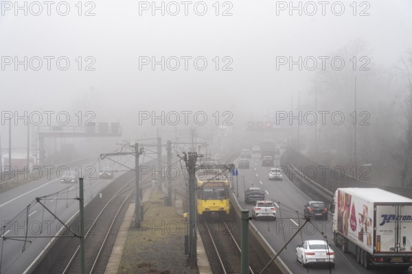 Dense fog, with visibility sometimes less than 100 metres, A40 motorway, city passage in Essen, underground line U18 in the middle lane, North Rhine-Westphalia, Germany, Europe