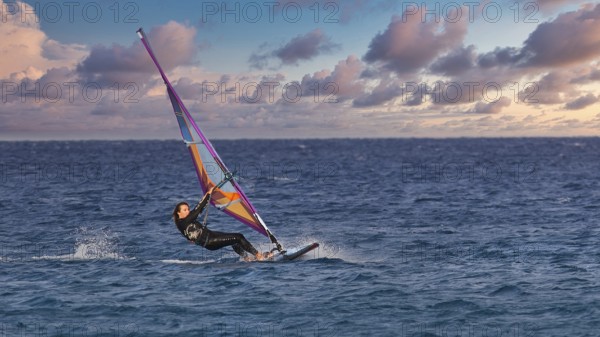Sky exchanged, colourful windsurfer on the sea with vivid sky, windsurfer, Meltemi windsurfing spot, Devils Bay, Paralia Vatha, Vatha Beach, southeast coast, Karpathos, Dodecanese, Greek Islands, Greece, Europe