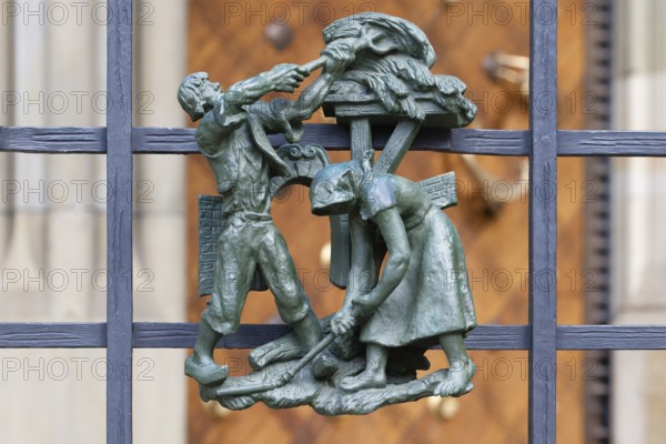 Prague castle, Gothic Metropolitan Cathedral of Saints Vitus, Wenceslas and Adalbert, Decorative figure of daily life scene on a fence, Prague, Czech Republic, Europe