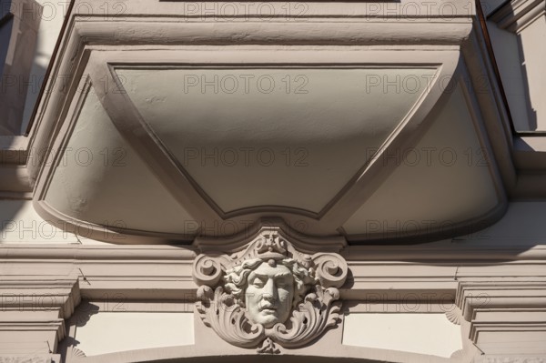 Relief of a head under a historic bay window, Würzburg, Lower Franconia, Bavaria, Germany, Europe