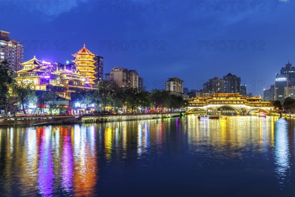 Chengdu Anshun Bridge over Jin River with pagoda at night in Chengdu, China, Asia
