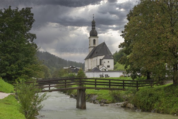 Parish church of St Sebastian, bridge, stream, rainy weather, Ramsauer Ache, Ramsau, Berchtesgadener Land, Upper Bavaria, Bavaria