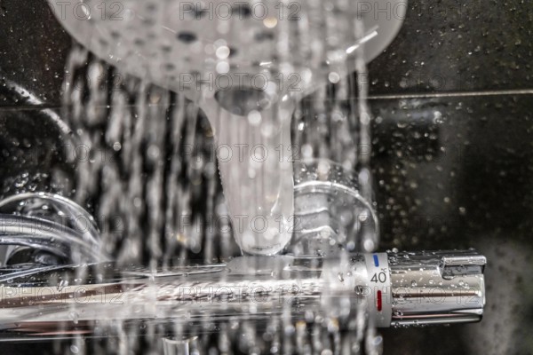 Shower, fitting, temperature control, temperature control of the shower water