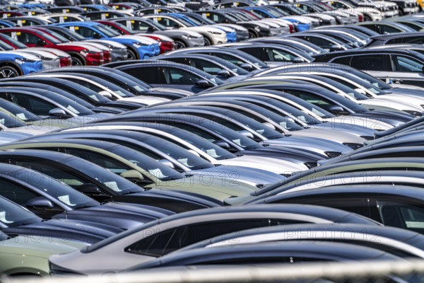 Storage area for new cars in the port of Vlissingen-Oost, vehicles are temporarily stored on over 100 hectares to ship them from Europe to the United Kingdom, Ford cars, others such as models from the Chinese car manufacturer BYD are delivered from here in Europe, wind farm, Netherlands