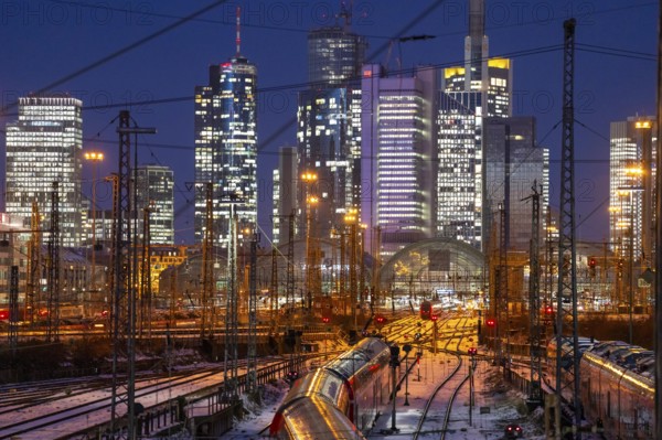 Railway tracks in front of the main railway station in Frankfurt am Main, skyline of skyscrapers in the Cit, winter, snow, dusk, Hesse, North Rhine-Westphalia