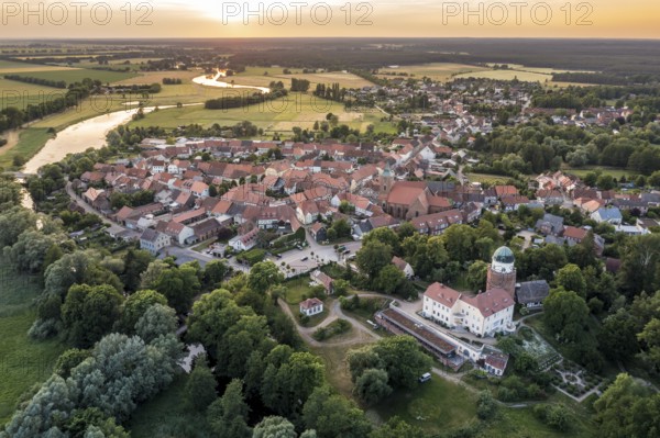 Aerial view of village Lenzen and river Loecknitz (Löcknitz) at sunset, Brandenburg, Germany, Europe