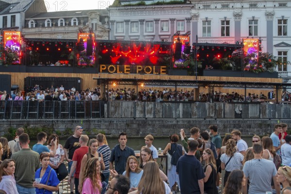 Spectators on grandstand at the Graslei watching Pole Pole podium during Gentse Feesten, Ghent city festival, summer festivities in Flanders, Belgium, Europe