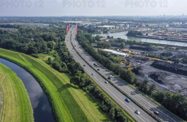 Bottrop, North Rhine-Westphalia, Germany - The Emscher has been completely free of wastewater since January 2022 following the construction of a parallel sewer. The river, shown here next to the A42 motorway, was previously an open, above-ground wastewater sewer, mixed sewer with surface water and wastewater. Bottrop harbour and Essen city harbour on the right of the Rhine-Herne Canal