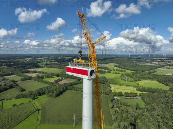 Dorsten, North Rhine-Westphalia, Germany, construction of a wind turbine, the first wind turbine of the Große Heide wind farm. A large mobile crane places the nacelle, the nacelle on the tower, Europe
