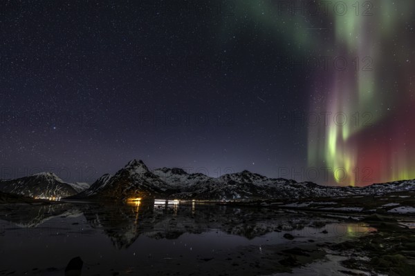 Northern lights over fjord, steep mountains, winter, aurora borealis, Flakstadoya, Lofoten, Norway, Europe
