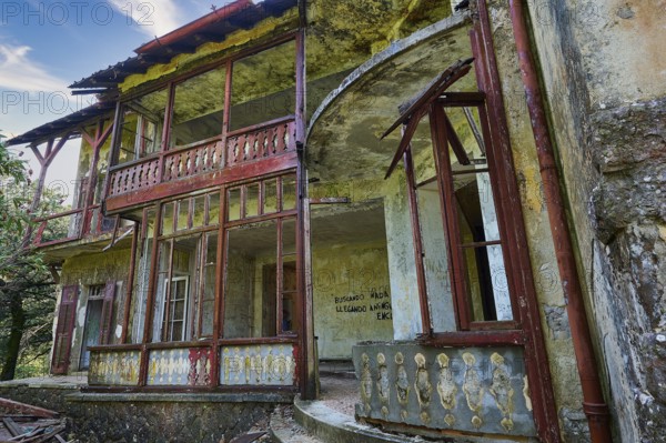 Sky replaced, Abandoned, dilapidated building with red doors and rusty railings, graffiti on the walls and dilapidated structures, Mussolini Villa, Villa de Vecchi, Profitis Ilias, Empona, Rhodes, Dodecanese, Greek Islands, Greece, Europe