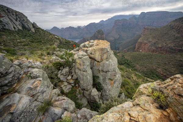 Young man on a rock, view of Blyde River Canyon with Mesa mountains, Upper Viewpoint, canyon landscape, Panorama Route, Mpumalanga, South Africa, Africa