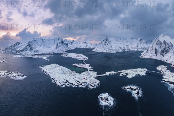 View of snow-covered islands, fjord and mountains, fishing villages Sakrisøy and Reine, Reinefjord, Lofoten, Norway, Europe