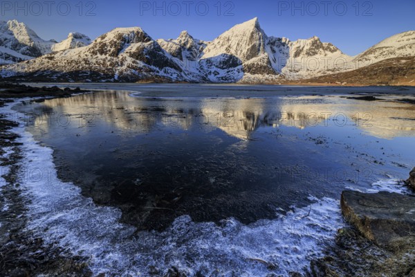 Sunrise, morning light, steep mountains and fjord, ice, winter, Flakstadoya, Lofoten, Norway, Europe
