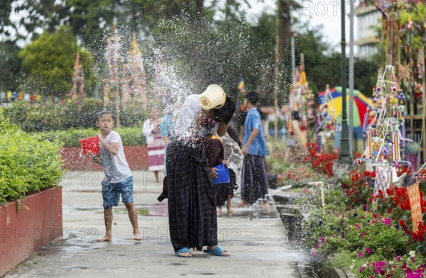 NAMSAI, INDIA.- APRIL 16: Devotees celebrate the vibrant Sangken Festival by pouring water over each other at Golden Pagoda in Namsai, India on 16 April 2025. Sangken Festival is a beautiful and culturally rich water festival celebrated primarily by the Theravada Buddhist communities, it marks the Buddhist New Year, typically falling in mid-April