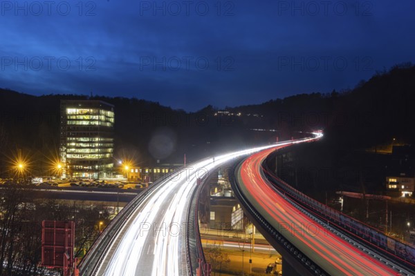 Federal road B14 at night, road bridge with traffic and light lanes. On the left the building of the Social Insurance for Agriculture, Forestry and Horticulture (SVLFG) . Stuttgart, Baden-Württemberg, Germany, Europe