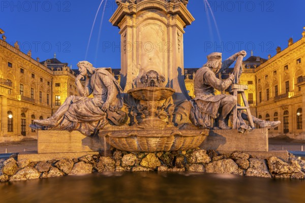 Frankonia Fountain with Walther von der Vogelweide and Tilman Riemenschneider in front of the Würzburg Residence at dusk, Würzburg, Bavaria, Germany, Europe