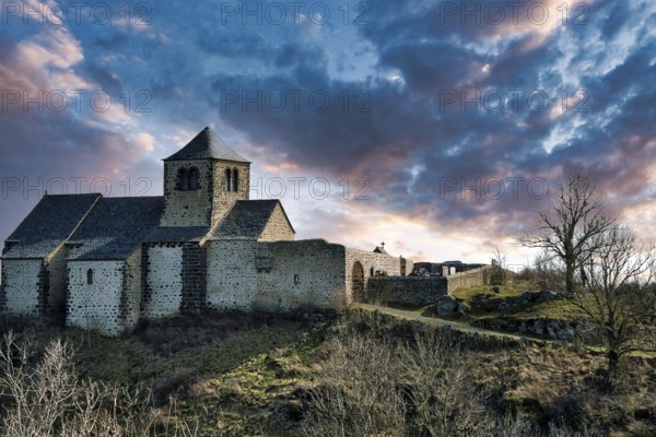 Dauzat-sur-Vodable. The Romanesque church of Saint-Géraud built on a basalt peak. Puy de Dome. Auvergne-Rhone-Alpes. France