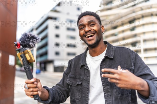 Handsome young african male influencer vlogging while walking along the city
