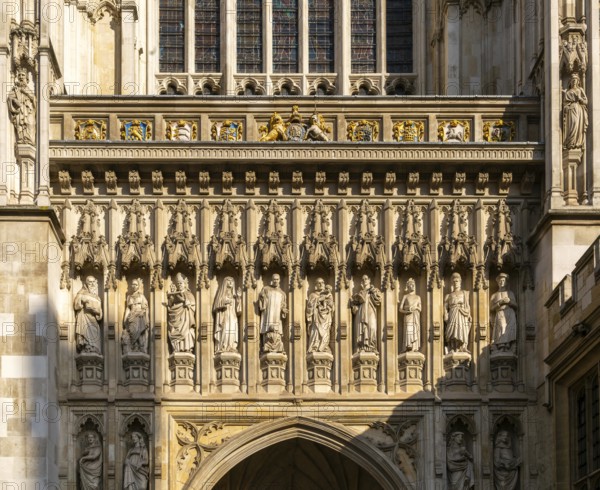 Carved stonework frieze above entrance door, Westminster abbey church, Westminster, London, England, UK
