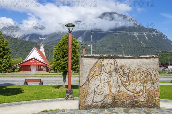 Relief of an indigenous woman and church in the village of Chaiten, Pumalin-Douglas Tompkins National Park, Chaiten, Los Lagos region, Patagonia, Chile, South America