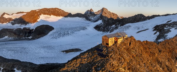 Atmospheric sunrise in a picturesque mountain landscape, alpenglow, aerial view, mountain hut Becherhaus at the summit Becher and glacier Übeltalferner, Stubai Alps, South Tyrol, Italy, Europe
