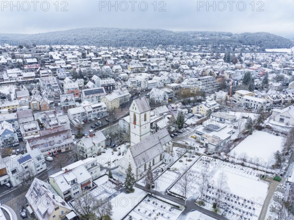 Snowy village landscape with church and surrounding buildings in a wintry setting, Aidlingen, Böblingen district, Germany, Europe