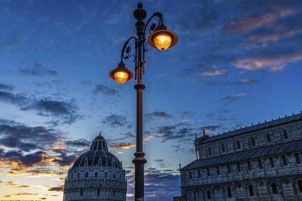 Baptistery and the Cathedral of Santa Maria Assunta at sunset under an illuminated street lamp, Pisa, Tuscany, Italy, Europe